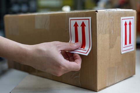 Shipping box with handling labels representing special promotions and discounts